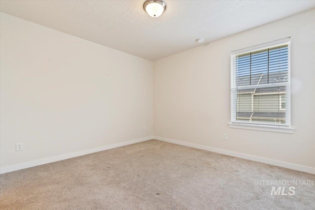 2312 E Spice Loop Unit 3, Nampa, ID 83687 - carpeted empty room with baseboards, a textured ceiling, and a smoke detector