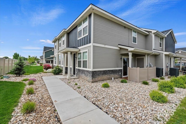 2312 E Spice Loop Unit 3, Nampa, ID 83687 - view of side of property featuring board and batten siding, central AC, and stone siding