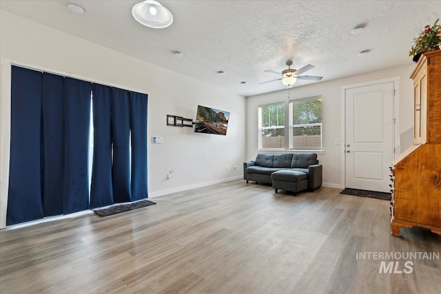 2312 E Spice Loop Unit 3, Nampa, ID 83687 - sitting room with a ceiling fan, wood finished floors, a textured ceiling, and baseboards