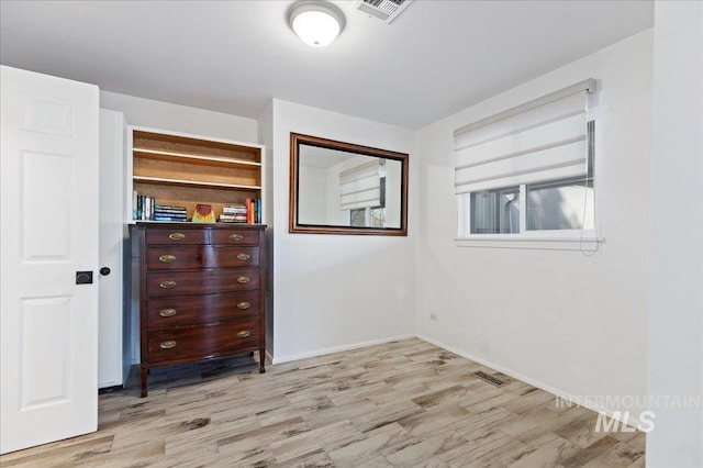 unfurnished bedroom with light wood-type flooring