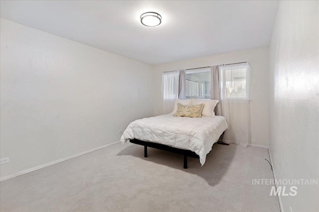 bedroom featuring light colored carpet