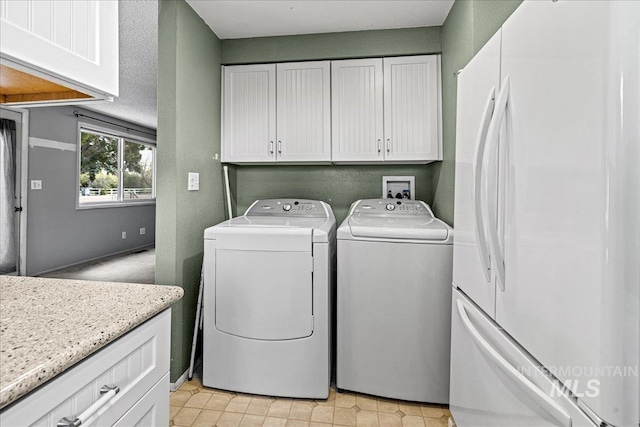 1267 NW Beaman St, Mountain Home, ID 83647 - clothes washing area featuring washing machine and dryer and cabinet space