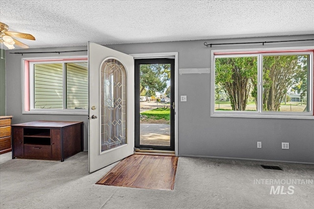 1267 NW Beaman St, Mountain Home, ID 83647 - carpeted entrance foyer with a textured ceiling and ceiling fan