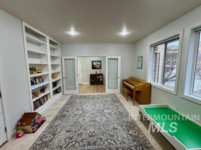 playroom with built in features and french doors