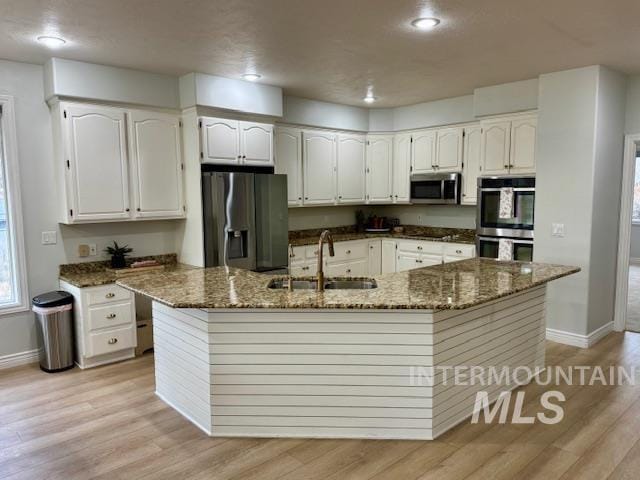 kitchen featuring white cabinets, appliances with stainless steel finishes, and a sink