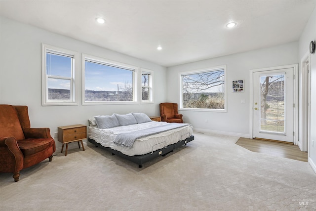 bedroom featuring access to exterior, recessed lighting, baseboards, and light carpet