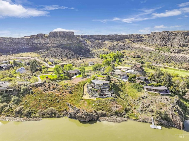 aerial view featuring a water and mountain view