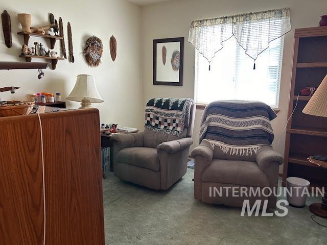 clothes washing area with light tile patterned floors, washing machine and clothes dryer, and cabinets