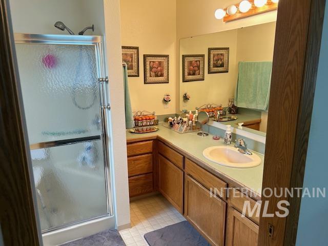 1100 Burnett Dr Unit 348, Nampa, ID 83651 - bathroom featuring a shower stall, vanity, and tile patterned floors