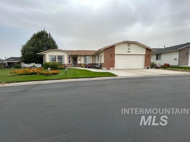 ranch-style home with a front yard, driveway, and an attached garage