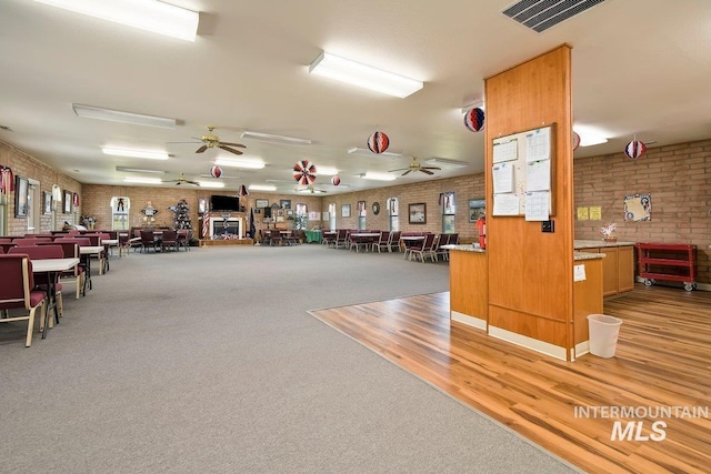1100 Burnett Dr Unit 348, Nampa, ID 83651 - miscellaneous room with a ceiling fan, visible vents, light wood-style flooring, and brick wall
