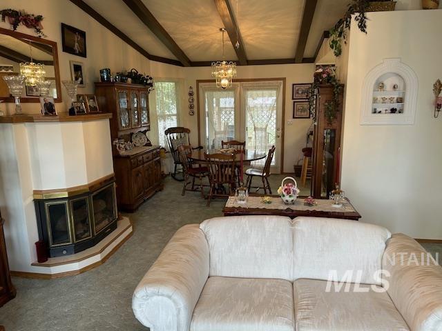 1100 Burnett Dr Unit 348, Nampa, ID 83651 - living area featuring vaulted ceiling with beams, carpet floors, and a chandelier