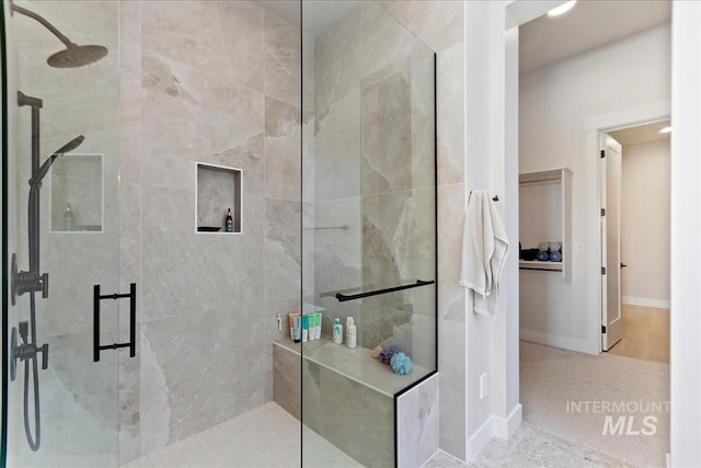 bathroom with a stall shower and baseboards