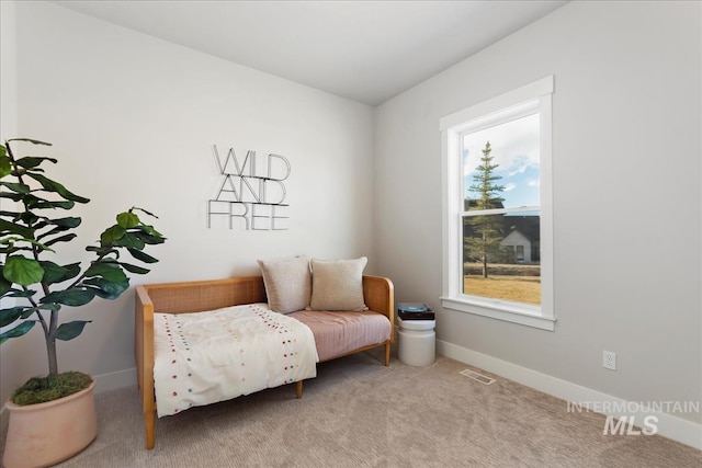 living area featuring carpet floors and baseboards