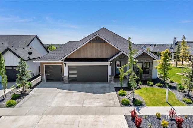 view of front of property with an attached garage, a shingled roof, a front yard, and driveway