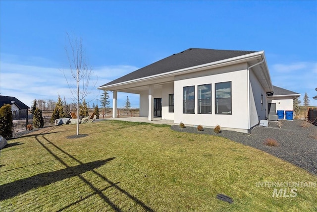 rear view of property with stucco siding and a patio