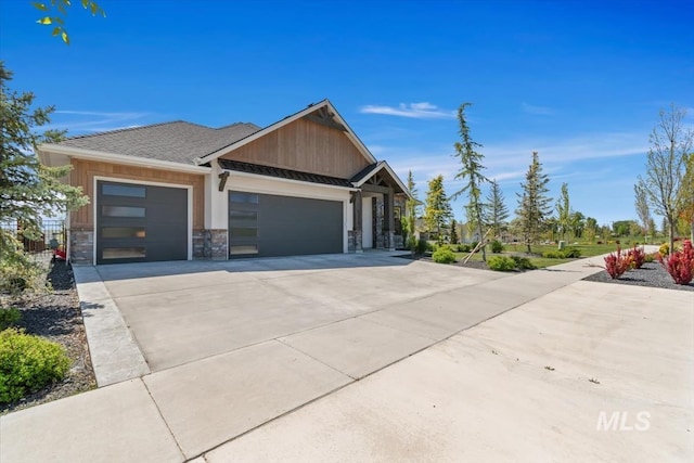 view of front of property with a garage, driveway, a standing seam roof, and board and batten siding