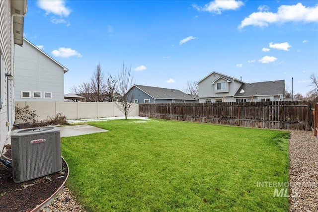 view of yard with a fenced backyard, cooling unit, and a patio