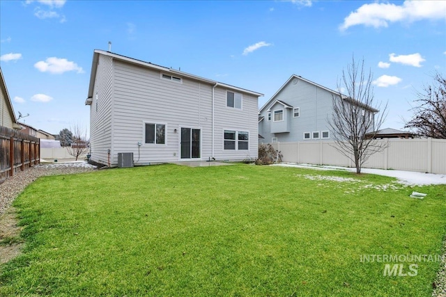 back of property with a yard, cooling unit, and a fenced backyard