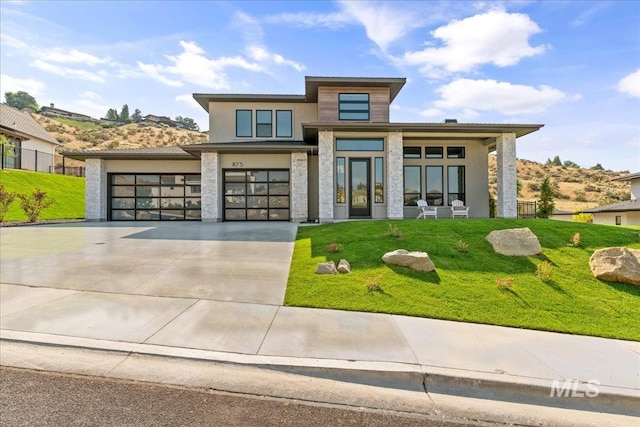 view of front of home with a front lawn and a garage