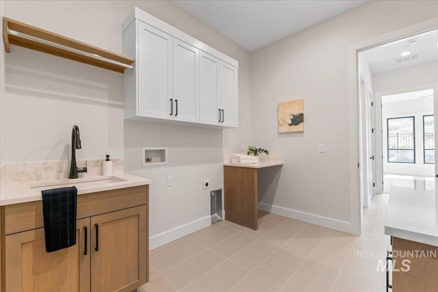 washroom with cabinets, sink, washer hookup, and hookup for an electric dryer