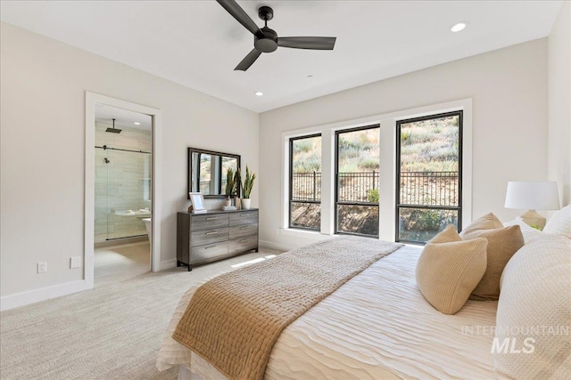 carpeted bedroom with ensuite bathroom and ceiling fan