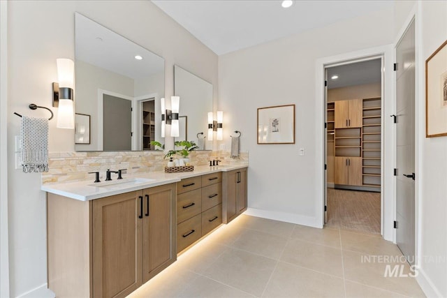 bathroom with tile patterned floors, decorative backsplash, and vanity