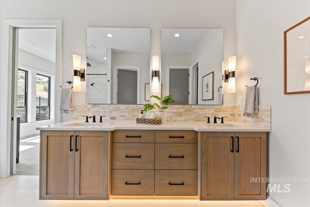 bathroom with vanity, tasteful backsplash, and walk in shower