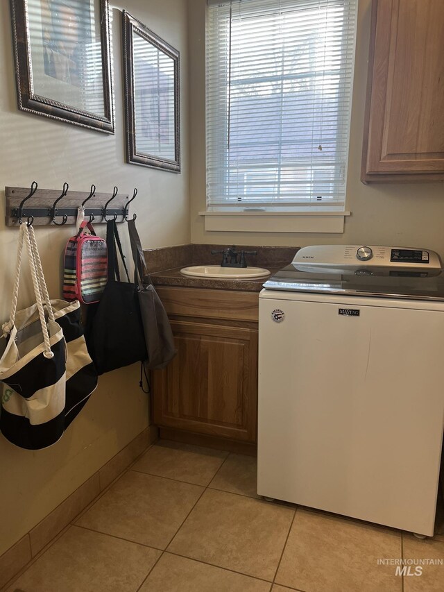 140 W Valley Rd, Hagerman, ID 83332 - washroom featuring washer / dryer, cabinet space, and light tile patterned flooring