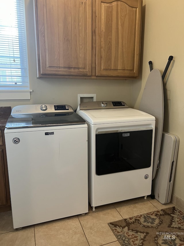 140 W Valley Rd, Hagerman, ID 83332 - laundry area with washer and clothes dryer, cabinet space, and light tile patterned floors