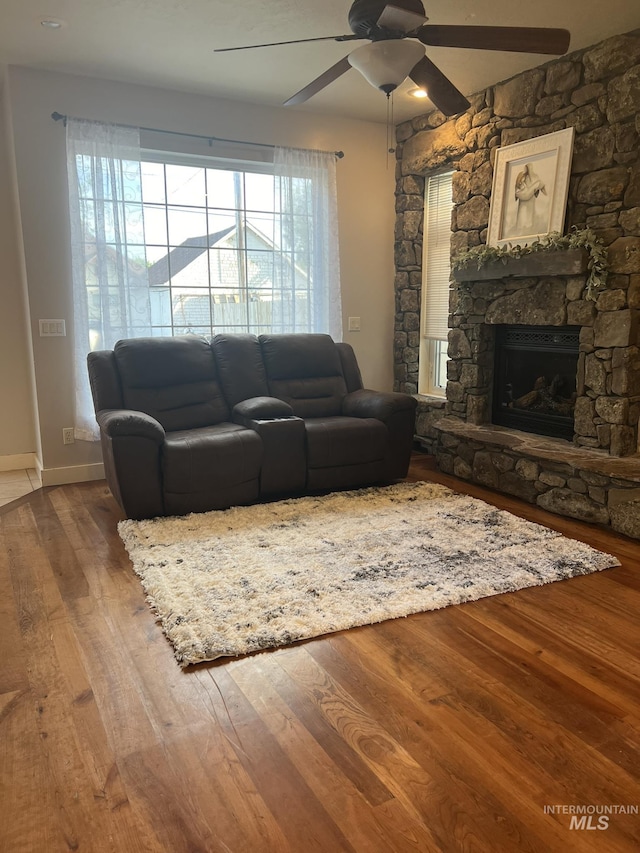 140 W Valley Rd, Hagerman, ID 83332 - living room with a ceiling fan, wood finished floors, a fireplace, and baseboards