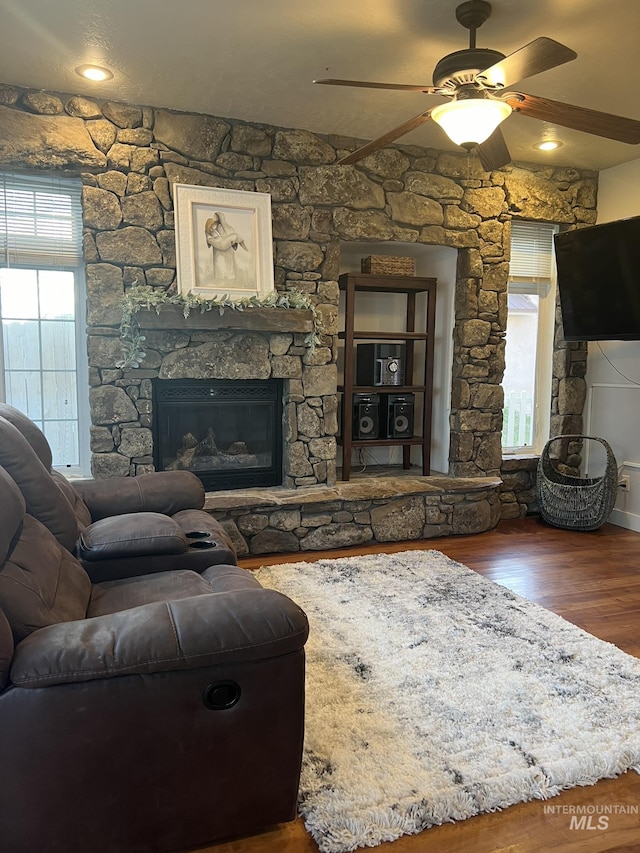 140 W Valley Rd, Hagerman, ID 83332 - living room featuring wood finished floors, a ceiling fan, and a fireplace