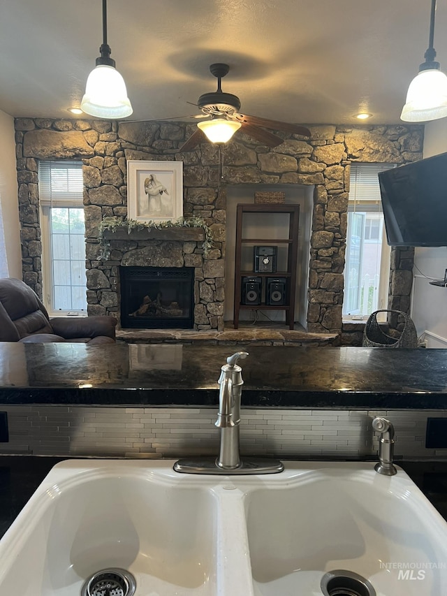 140 W Valley Rd, Hagerman, ID 83332 - detailed view of a sink, a fireplace, a ceiling fan, and pendant lighting