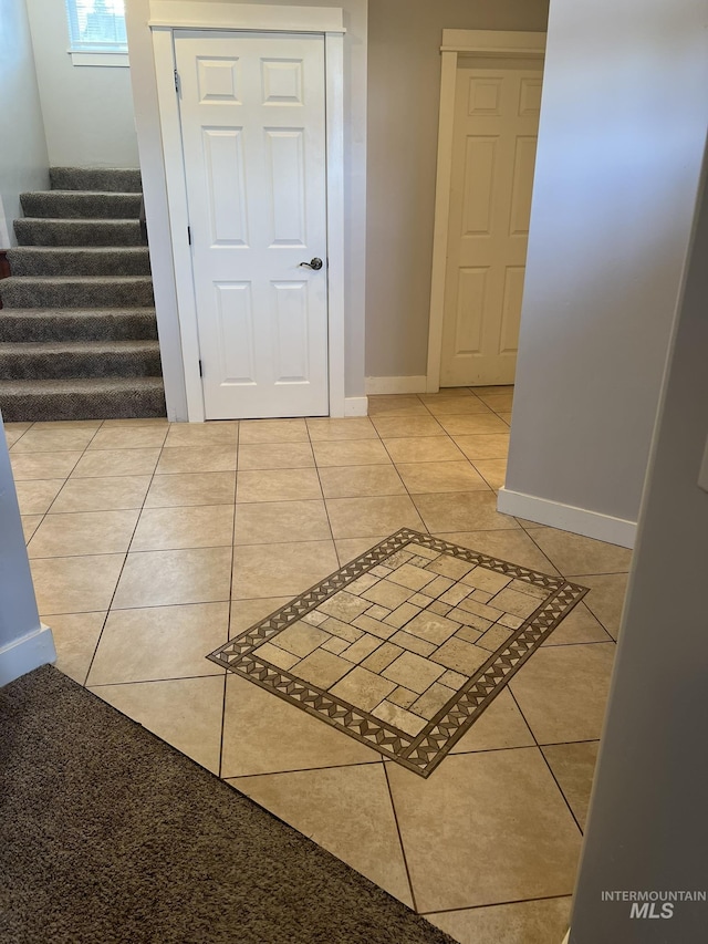 140 W Valley Rd, Hagerman, ID 83332 - corridor with stairway, light tile patterned floors, and baseboards