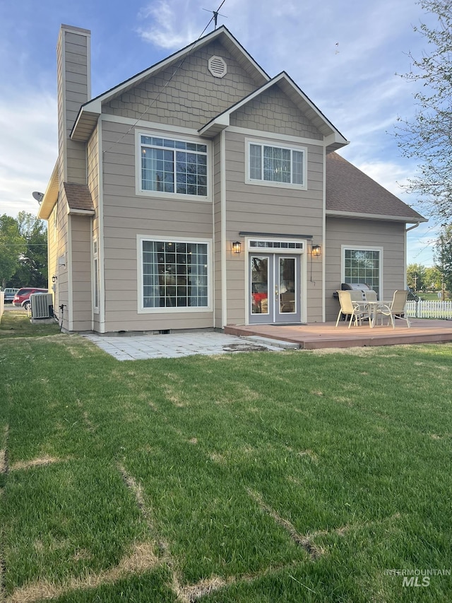 140 W Valley Rd, Hagerman, ID 83332 - rear view of house featuring central AC unit, a yard, a chimney, and a wooden deck