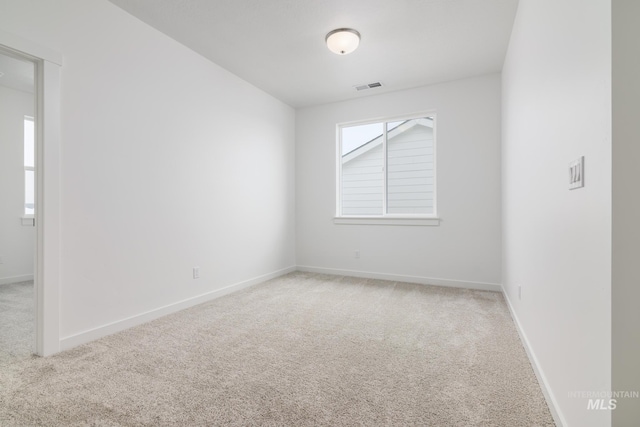 carpeted spare room with a wealth of natural light