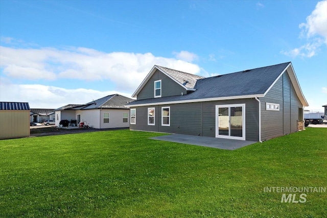 back of house with a yard and a patio area