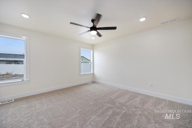 empty room featuring ceiling fan and carpet flooring