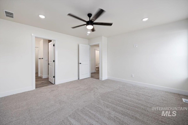 unfurnished bedroom with carpet floors, connected bathroom, and ceiling fan