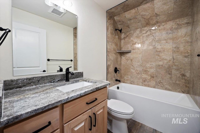 full bathroom with vanity, toilet, tiled shower / bath combo, and wood-type flooring