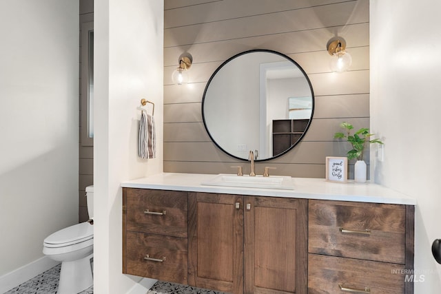 bathroom featuring tile patterned floors, vanity, and toilet