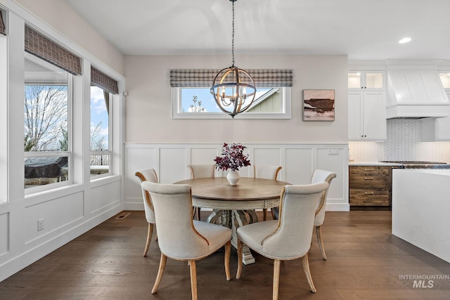 dining area featuring dark hardwood / wood-style floors and a notable chandelier