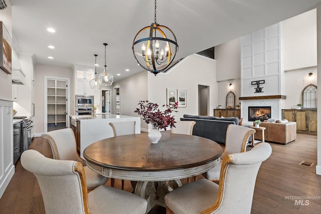 dining space featuring light wood-type flooring and a notable chandelier