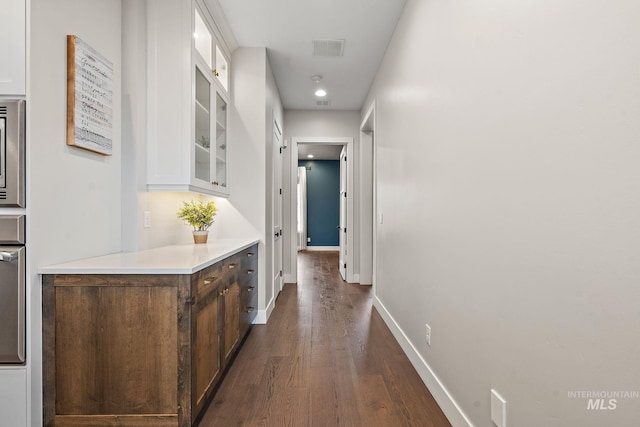 hall with dark wood-type flooring