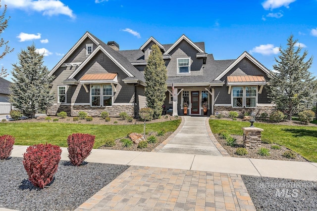 craftsman-style home with a front yard