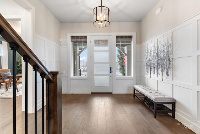 entryway featuring hardwood / wood-style floors and a chandelier
