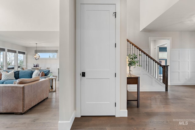 foyer entrance with hardwood / wood-style flooring and a chandelier