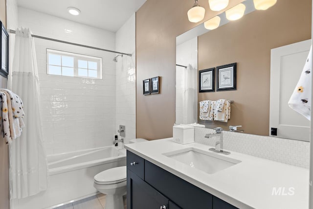 full bathroom with tile patterned flooring, shower / tub combo, vanity, and toilet