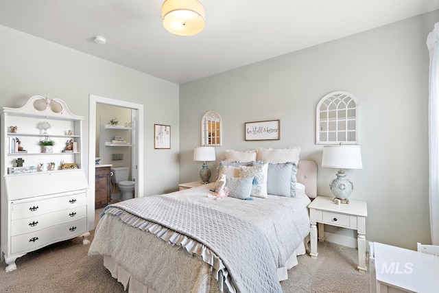 bedroom with carpet and connected bathroom