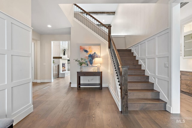 staircase with hardwood / wood-style flooring
